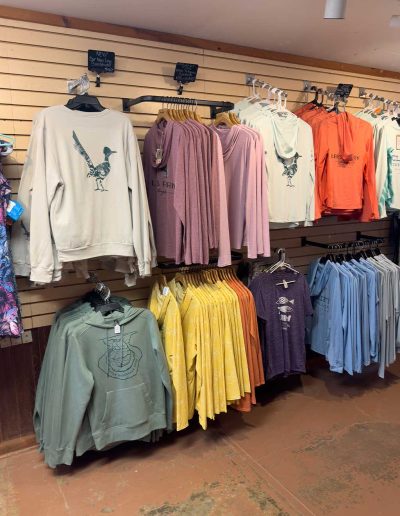 cliffdwellers clothing Assorted colorful sweatshirts displayed in store
