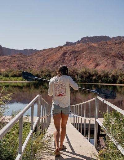 cliffdwellers general store (25) Woman holding paddle on bridge near river and mountains