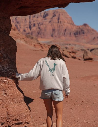 cliffdwellers general store (27) Woman exploring arid desert landscape near rock arch