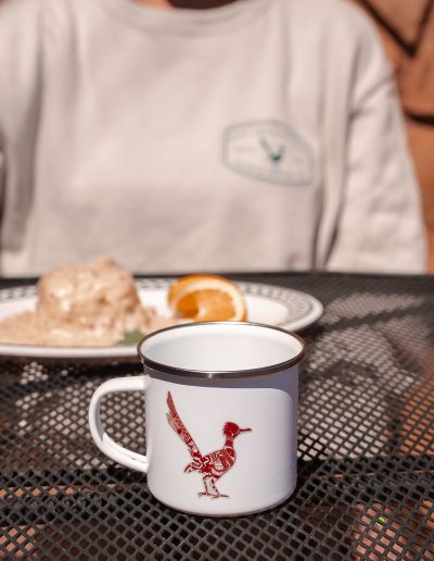 cliffdwellers general store (43) Mug with bird design on outdoor mesh table