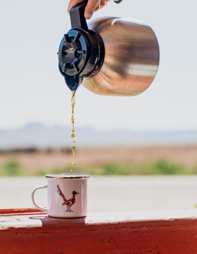 cliffdwellers general store (45) Hand pouring coffee into mug outdoors