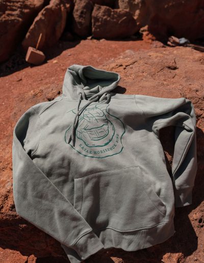 cliffdwellers general store (46) Green hoodie with logo on rocky desert surface