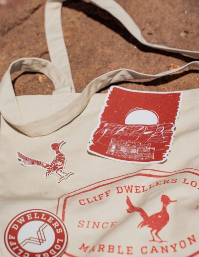 cliffdwellers general store (50) Cliff Dwellers tote bag on sandy ground